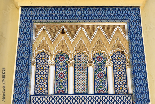 Architectural detail in Fez Royal palace, Morocco. Carved stone and mosaic tilework
