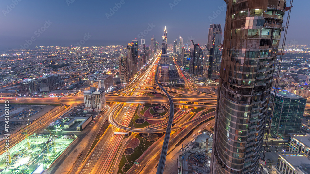 Obraz premium Scenic Dubai downtown skyline day to night timelapse. Rooftop view of Sheikh Zayed road