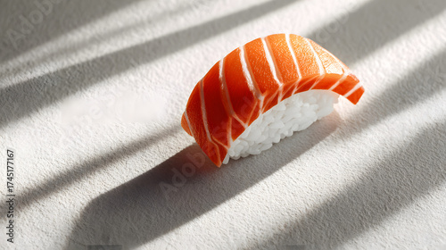 Minimal composition of one sushi on light textured surface with clear top area for branding