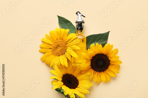 Bottle of oil with sunflowers on beige background