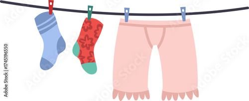 Clothesline with clean laundry drying on clothespins