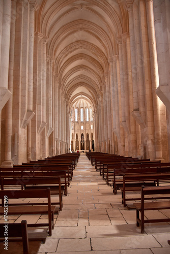 Interior view of the Alcobaca church with tall columns and ribbed vault in a Portuguese heritage site