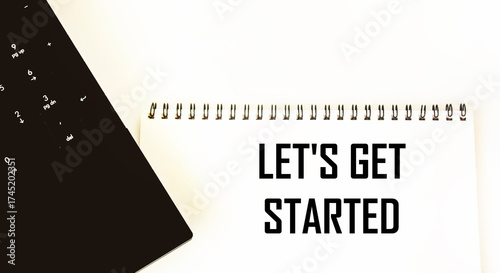 Let's start with the text on the notepad next to the laptop