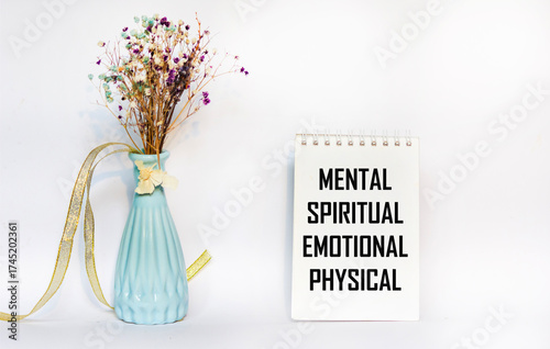 Mental Spiritual Emotional Physical, written on a notebook