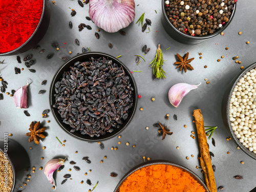 Colorful assortment of spices and herbs on a gray surface for culinary inspiration and cooking creativity