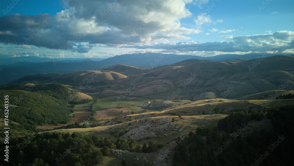 Fototapeta premium Drone aerial view of Castel del Monte, Abruzzo, a medieval hilltop village with ancient stone architecture and panoramic landscapes