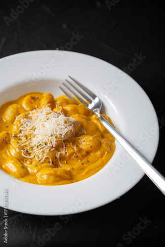Gnocchi in pumpkin sauce with Parmesan cheese