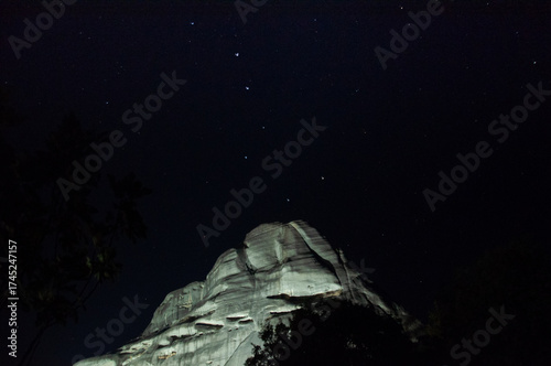 Scenic marble mountain at night with cosmic sky and Little Dipper above