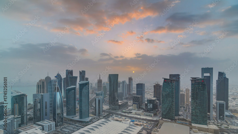 Fototapeta premium Skyscrapers at sunset timelapse in the skyline of commercial center of Doha, the capital Qatar