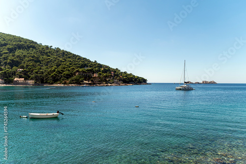 Beautiful coastline view of Dubrovnik, Croatia with calm waters and sailing boats
