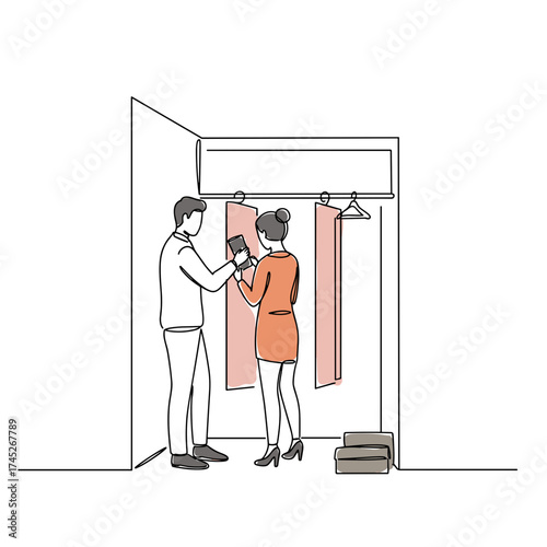 Young couple trying on clothes in fitting room while smiling