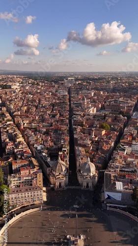 Aerial drone footage over Rome showcasing Piazza del Popolo with twin baroque churches Santa Maria in Montesanto and Santa Maria dei Miracoli, iconic cinematic landmark of Italian heritage