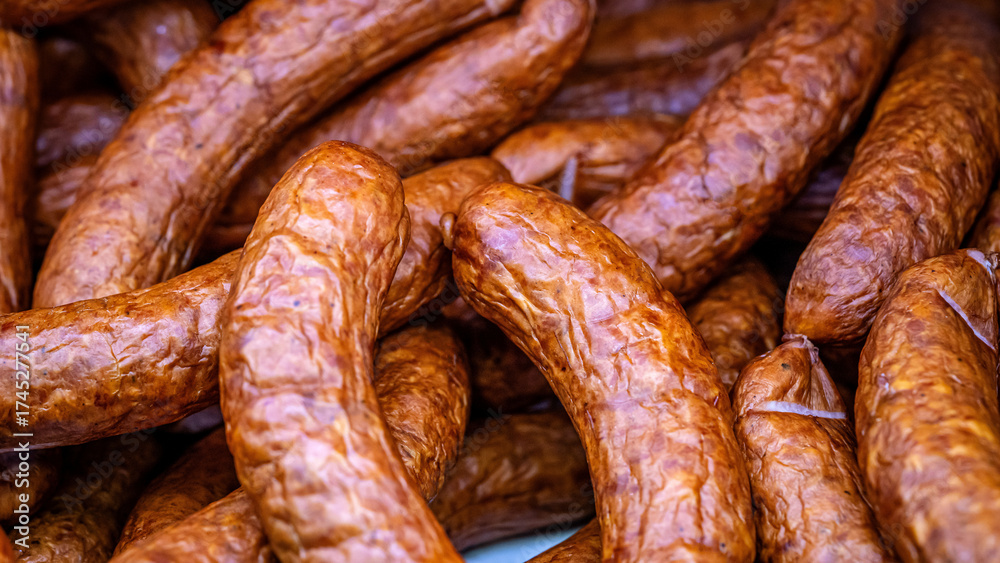 Fototapeta premium Closeup of smoked sausages stacked together