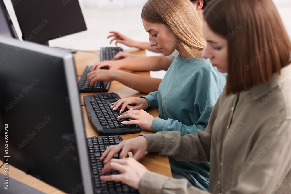 Fototapeta premium Students taking online exam indoors, selective focus