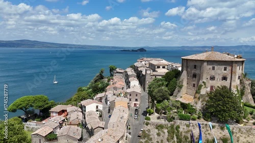 Drone aerial view of Capodimonte, Lazio, overlooking Lake Bolsena with charming streets, medieval architecture, and lakeside scenery