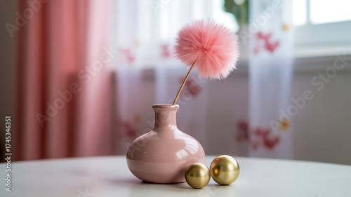 A minimalist still life photograph of a pale pink ceramic bud vase with a bulbous shape and rounded bottom.