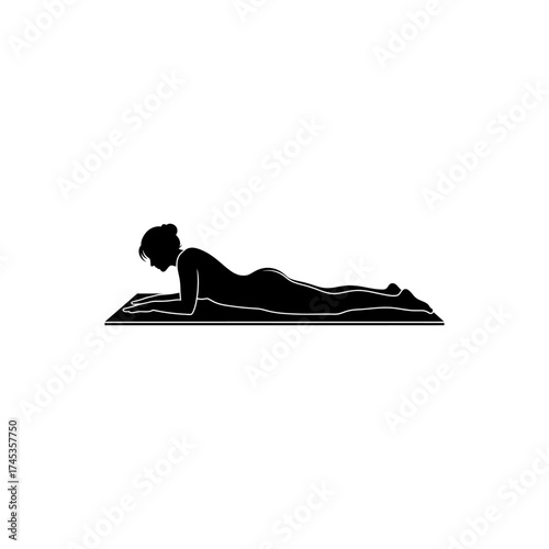 Silhouette of woman lying on stomach on yoga mat with elbows on the ground