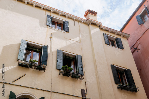 Wall Mural Traditional Mediterranean residential building facade with green wooden shutters