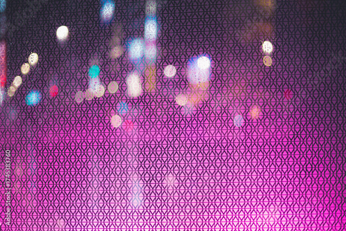 Abstract background of bright pink texture with colorful light bokeh spots.