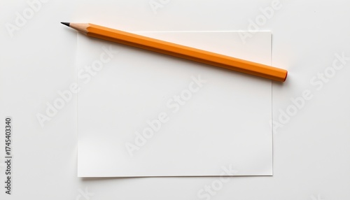 Wallpaper Mural A single pencil resting atop a blank piece of paper, which is positioned against a light background. Torontodigital.ca