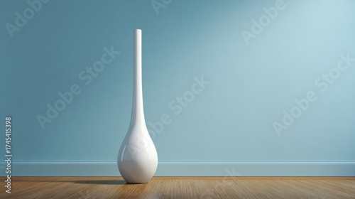 An elegant minimalist interior featuring a tall slender white vase on polished wooden flooring against a light blue wall