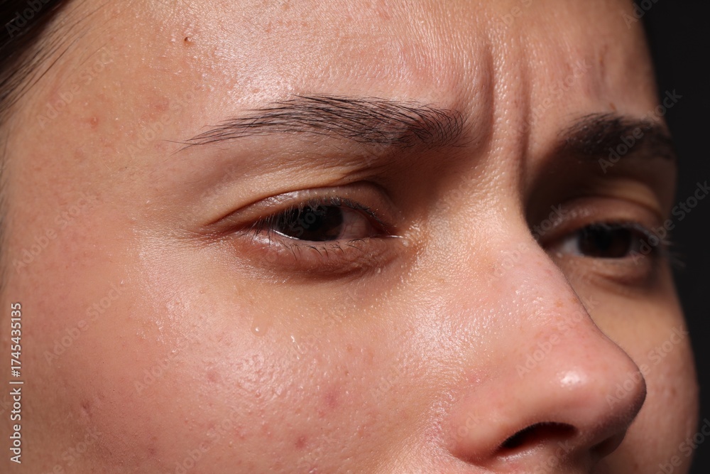 Fototapeta premium Closeup view of sad young woman crying