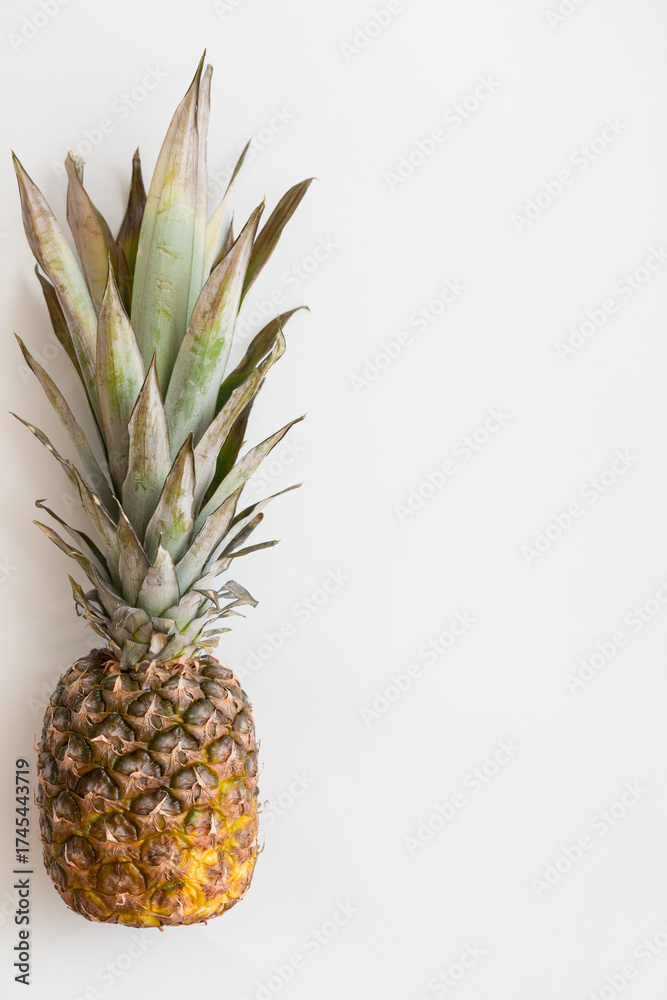 Obraz premium Top view on fresh juicy pineapple on white background. Close up