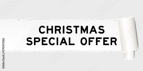 Ripped gray paper background that have word christmas special offer under torn part