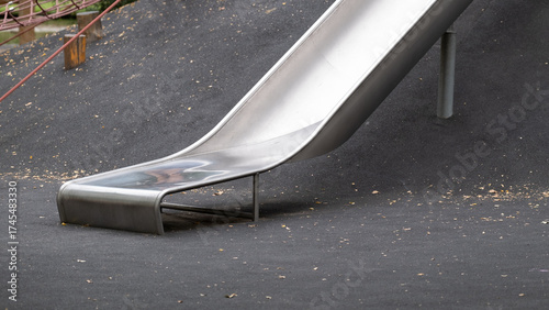 Metal playground slide on rubber safety surface