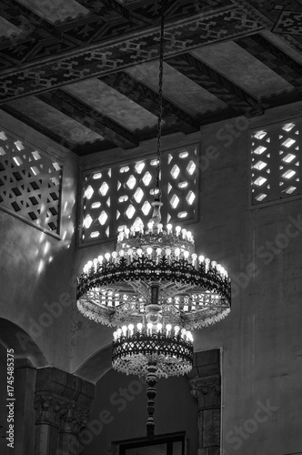 Interior of a Moorish Architecture Building with Window Vents and a Ceiling Light in Black and White.