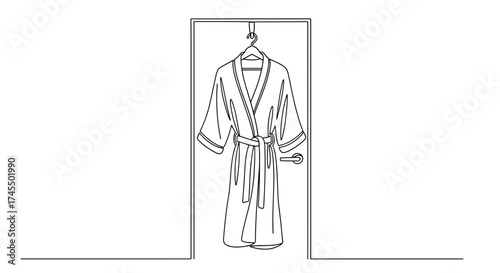 Robe hanging on bathroom door in linear black and white style