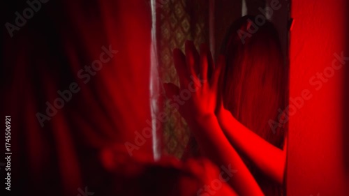 Eerie Halloween Concept of Possessed Woman in Front of Mirror Under Flickering Light
