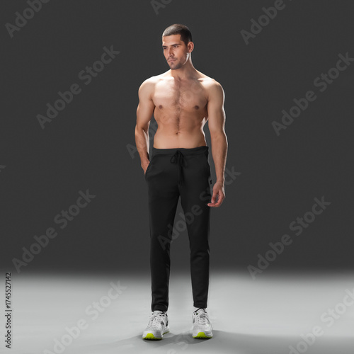 Fit young man wearing sportswear standing in studio