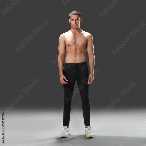 Fit young man wearing sportswear standing in studio