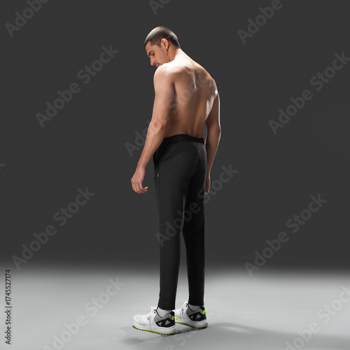 Fit young man wearing sportswear standing in studio