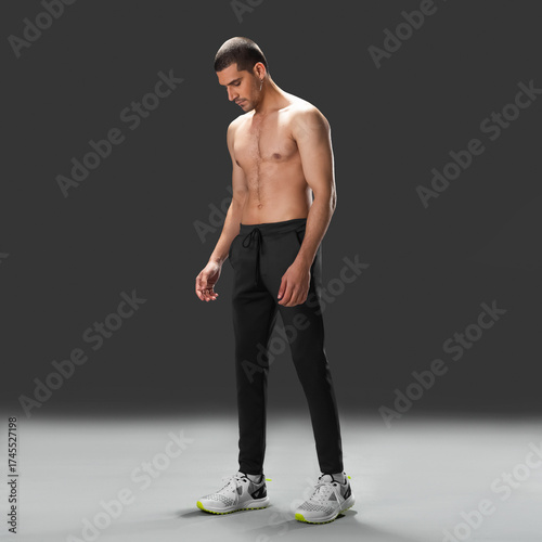 Fit young man wearing sportswear standing in studio