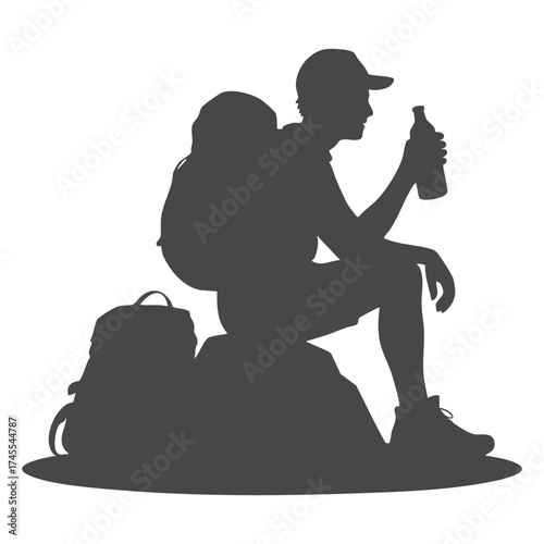 Hiker resting on a rock drinking water silhouette