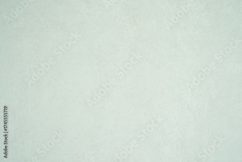 A minimalist textured light gray wall surface with subtle patterns and a soft matte finish