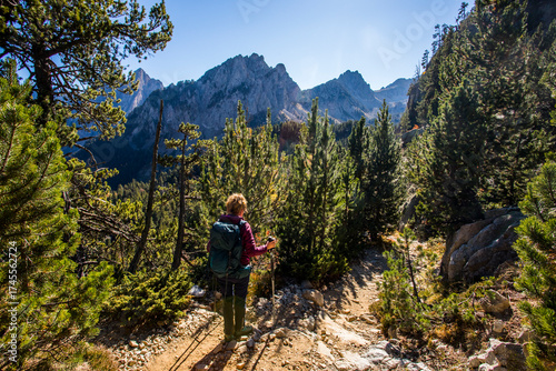 Wallpaper Mural Young hiker woman in autumn in Aiguestortes and Sant Maurici National Park, Spain Torontodigital.ca