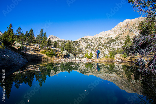 Wallpaper Mural Young hiker woman in autumn in Aiguestortes and Sant Maurici National Park, Spain Torontodigital.ca