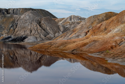 Landscape of an old abandoned refractory clay quarry (Ural Mars) on an August evening. Sverdlovsk region, Russia