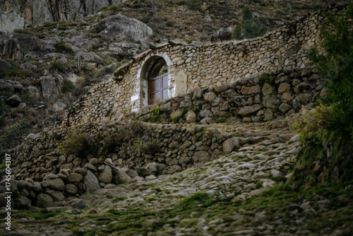 Stone houses with wooden doors and balconies in the traditional village of Tupe, Peru