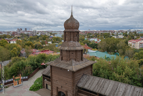 The wooden tower of the Tomsk Kremlin against the backdrop of a cityscape on a cloudy September day