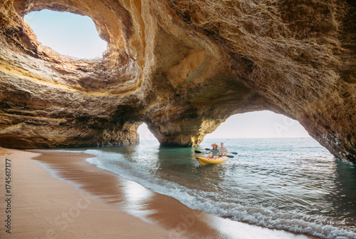 Couple on a kayak exploring the Benagil sea cave in Algarve