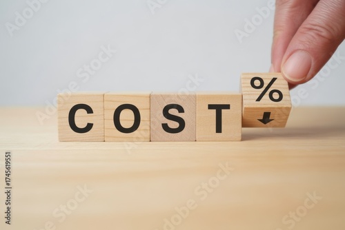 Cost Reduction Concept: Hand flips a cube to display a percentage decrease, visualizing the concept of lowering costs and improving financial efficiency. 