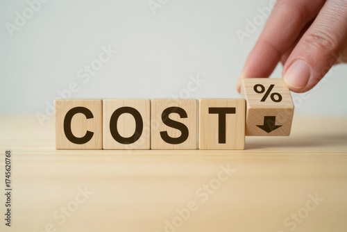 Cost Reduction: A hand strategically positions a wooden cube to symbolize and achieve the critical target of cost reduction, illustrating efficiency and financial prudence. 