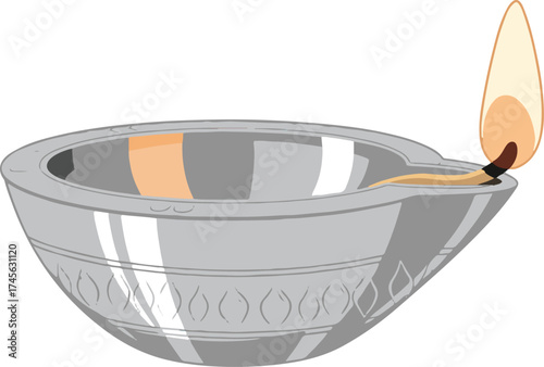 A beautifully illuminated traditional metallic oil lamp, commonly recognized as a diya, featuring a gentle, warm flame. 