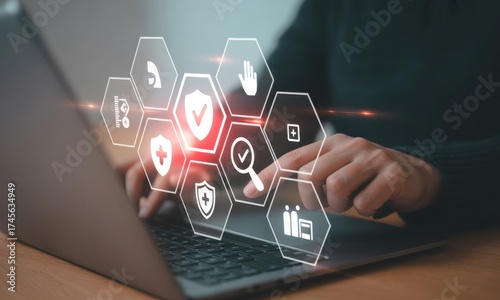Digital Security Interface: a person engaged in secure operations in front of a modern laptop, with the interface illuminating vital digital protection features.