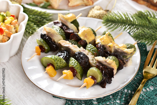Herring fillet skewers with prune and pickles for Christmas