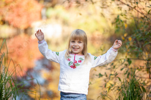 Joyful Child Celebrating Autumn in a Colorful Outdoor Setting During Halloween Season in October
